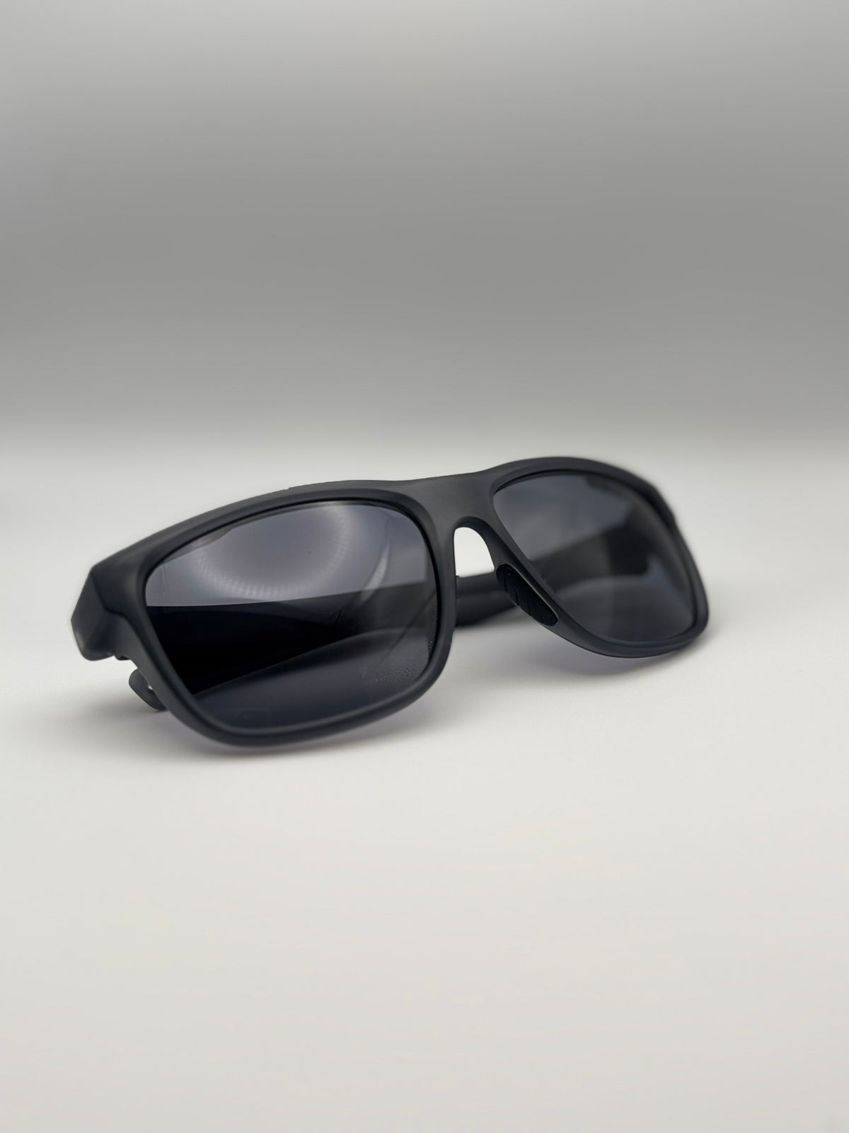 Black sunglasses on a light gray background