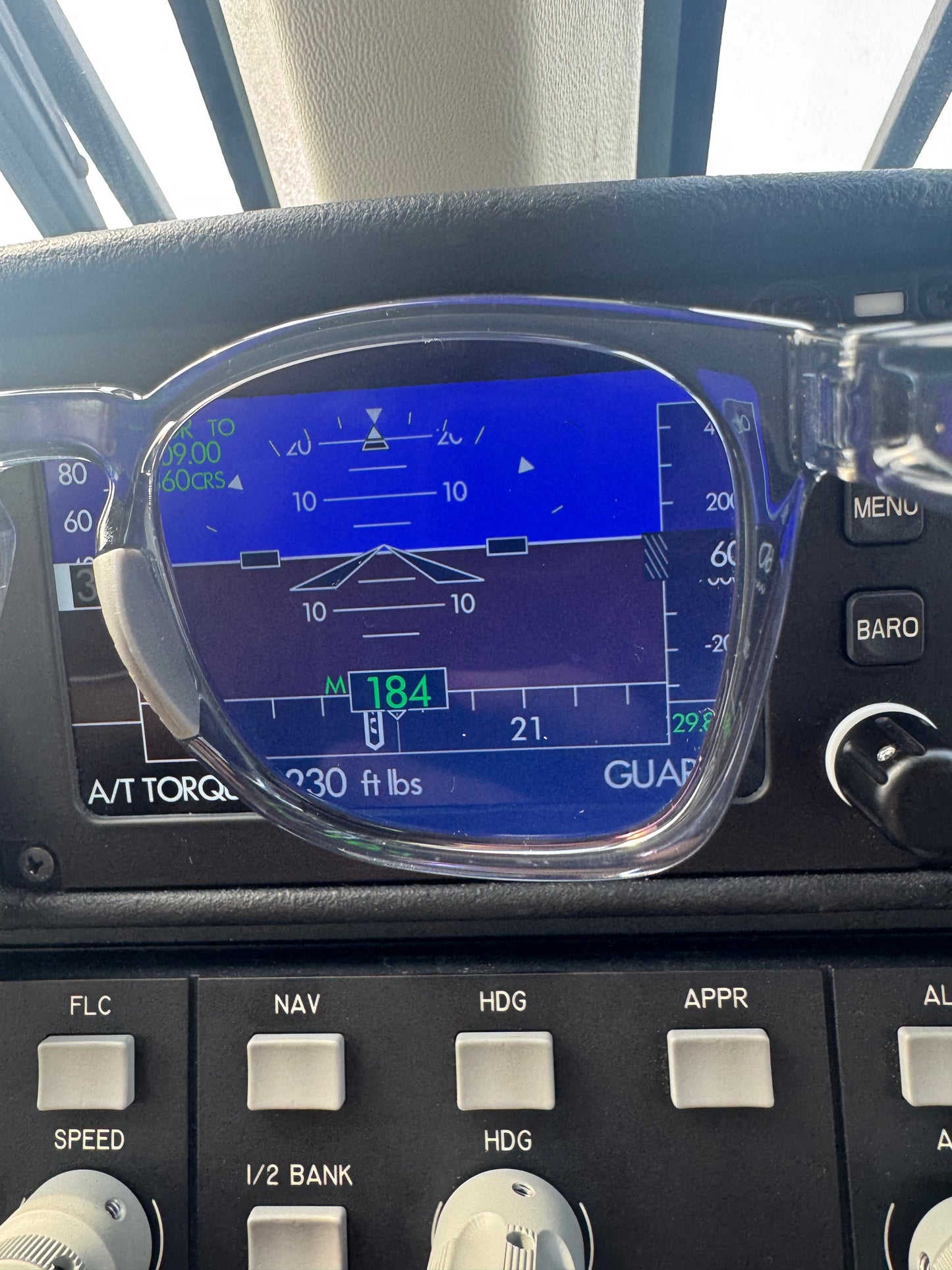 Close-up of a flight instrument panel with a digital display showing altitude and other flight data.