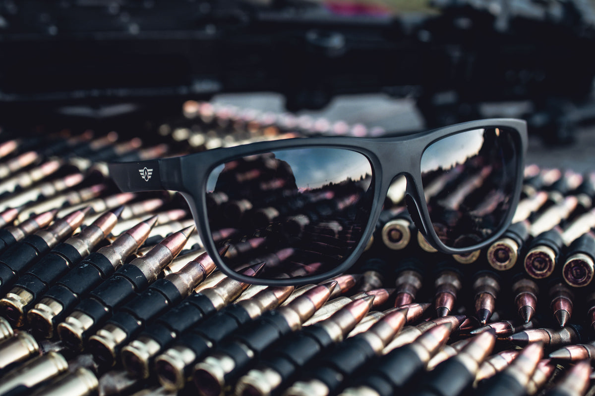 Black sunglasses on a pile of ammunition.