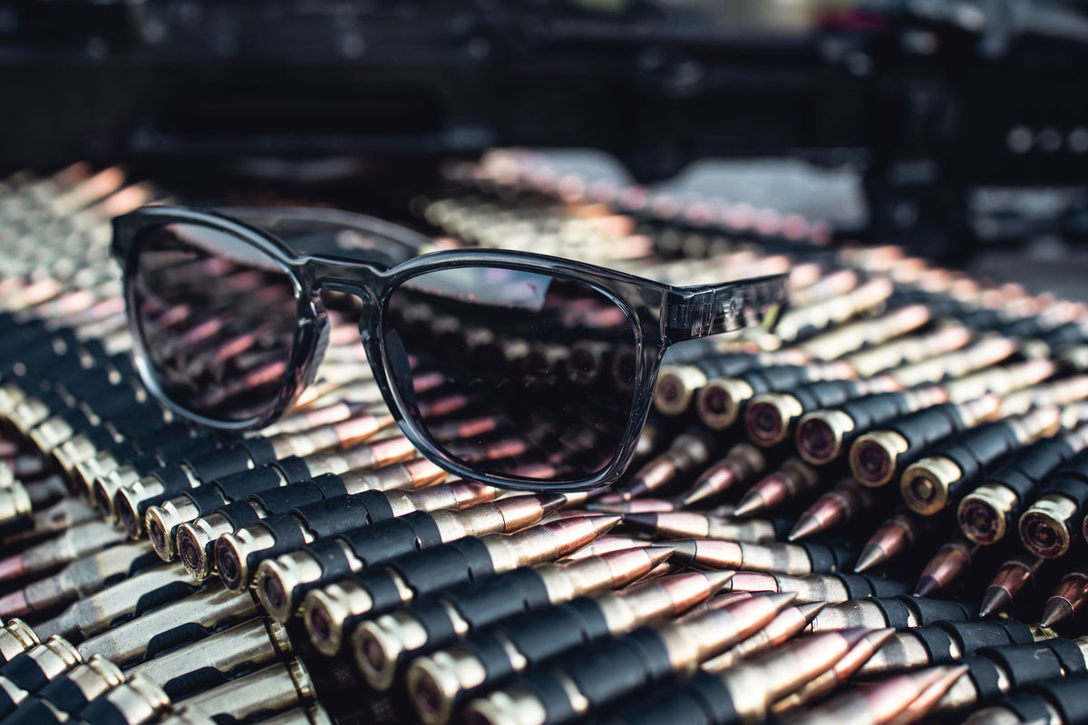 Sunglasses on a pile of ammunition with a blurred background