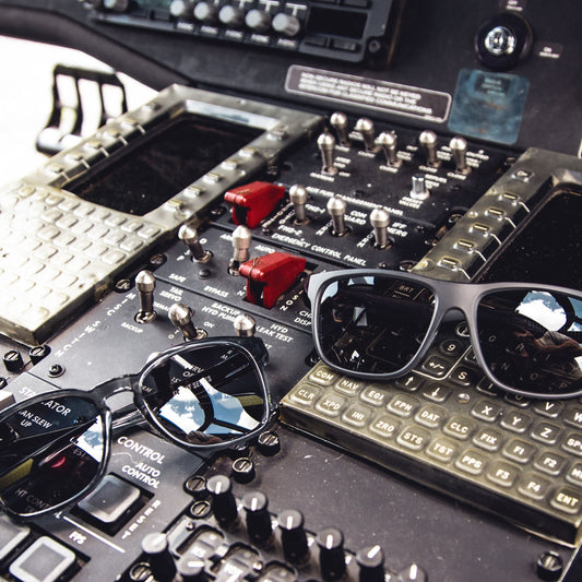Sunglasses on a control panel with buttons and switches