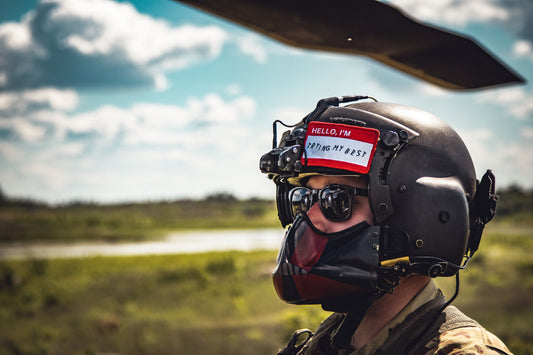 Person wearing a helmet with communication equipment in an outdoor setting
