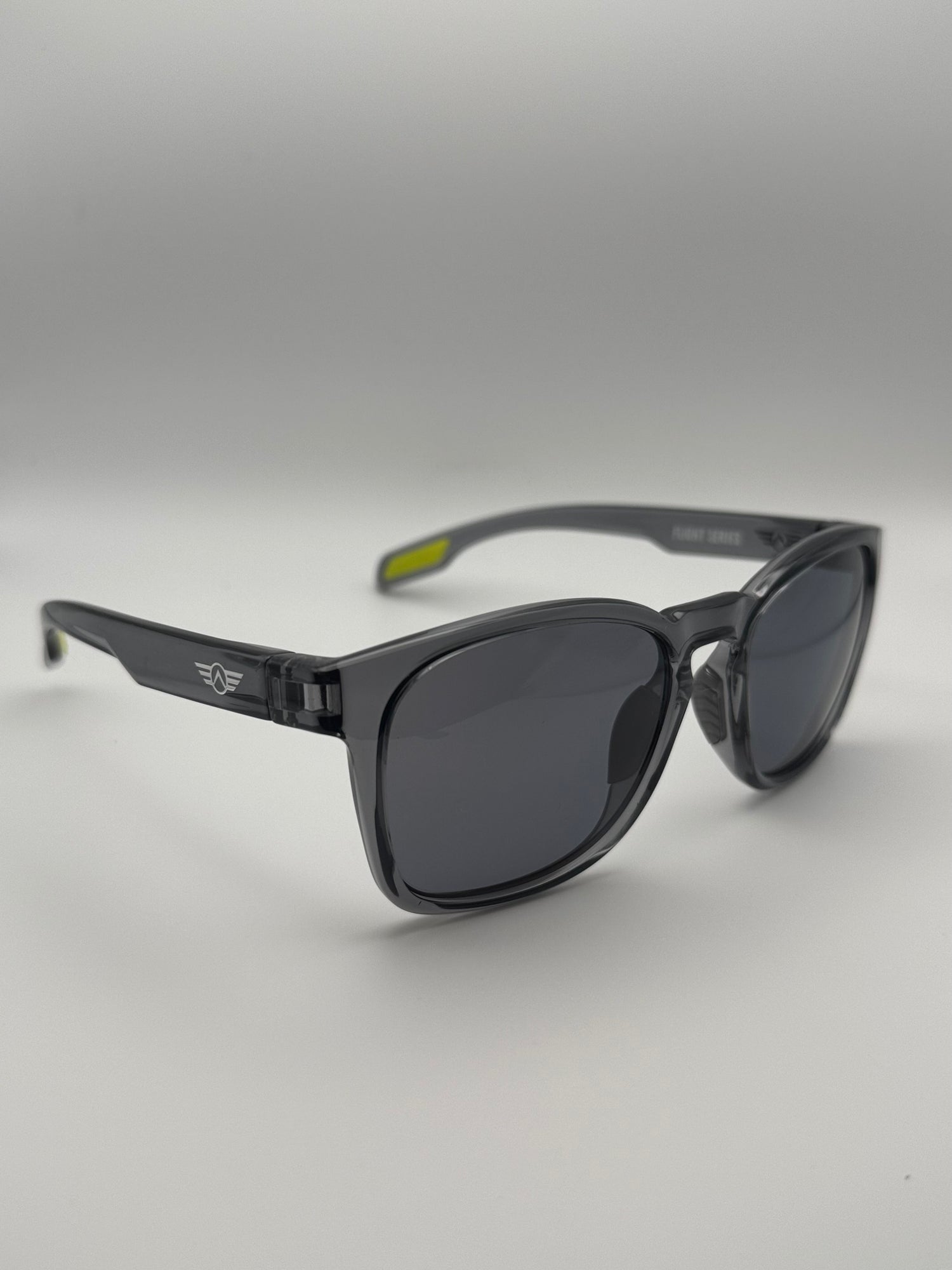 Black sunglasses with a gray gradient lens on a light gray background