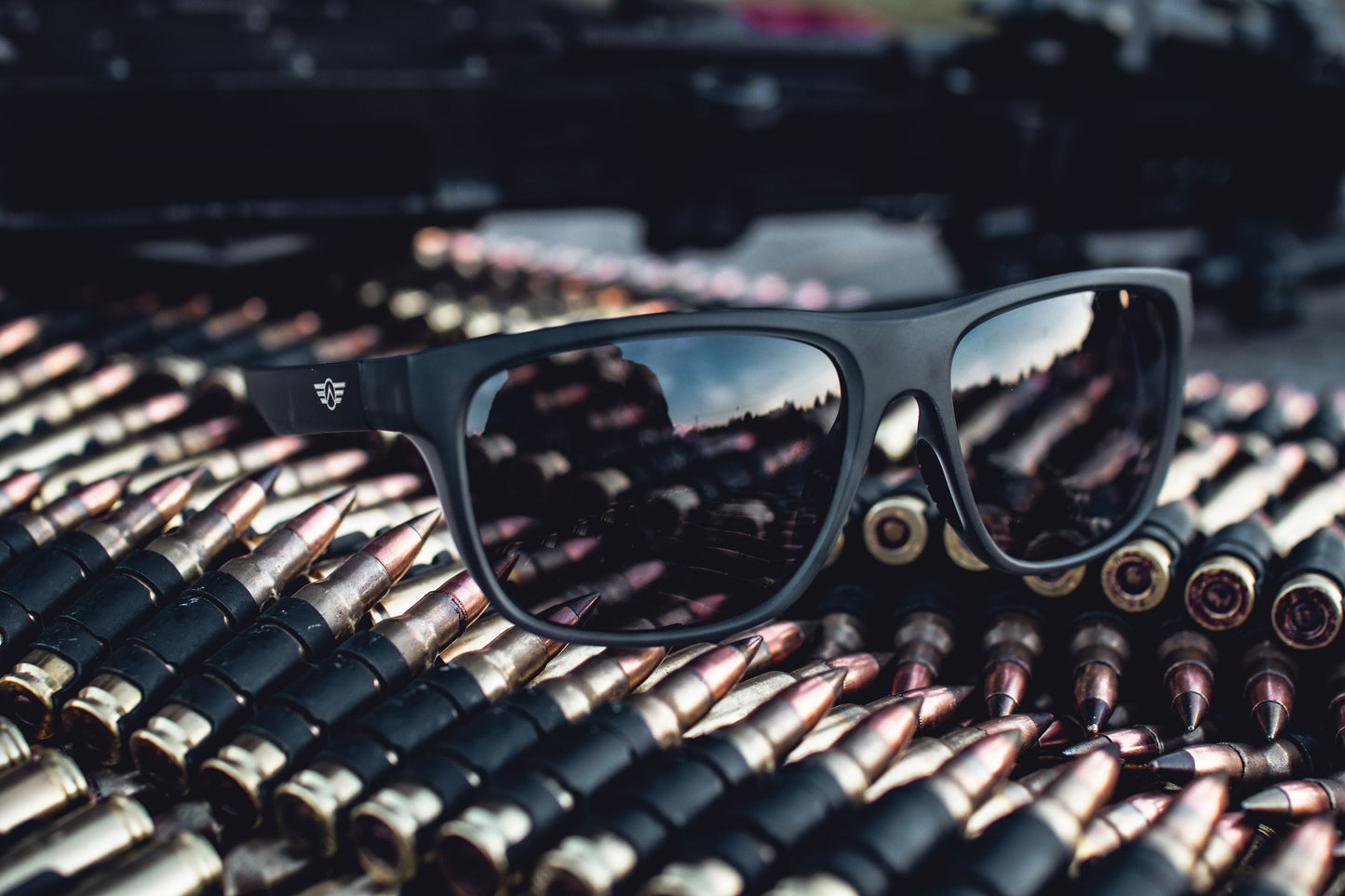 Black sunglasses on a pile of ammunition.