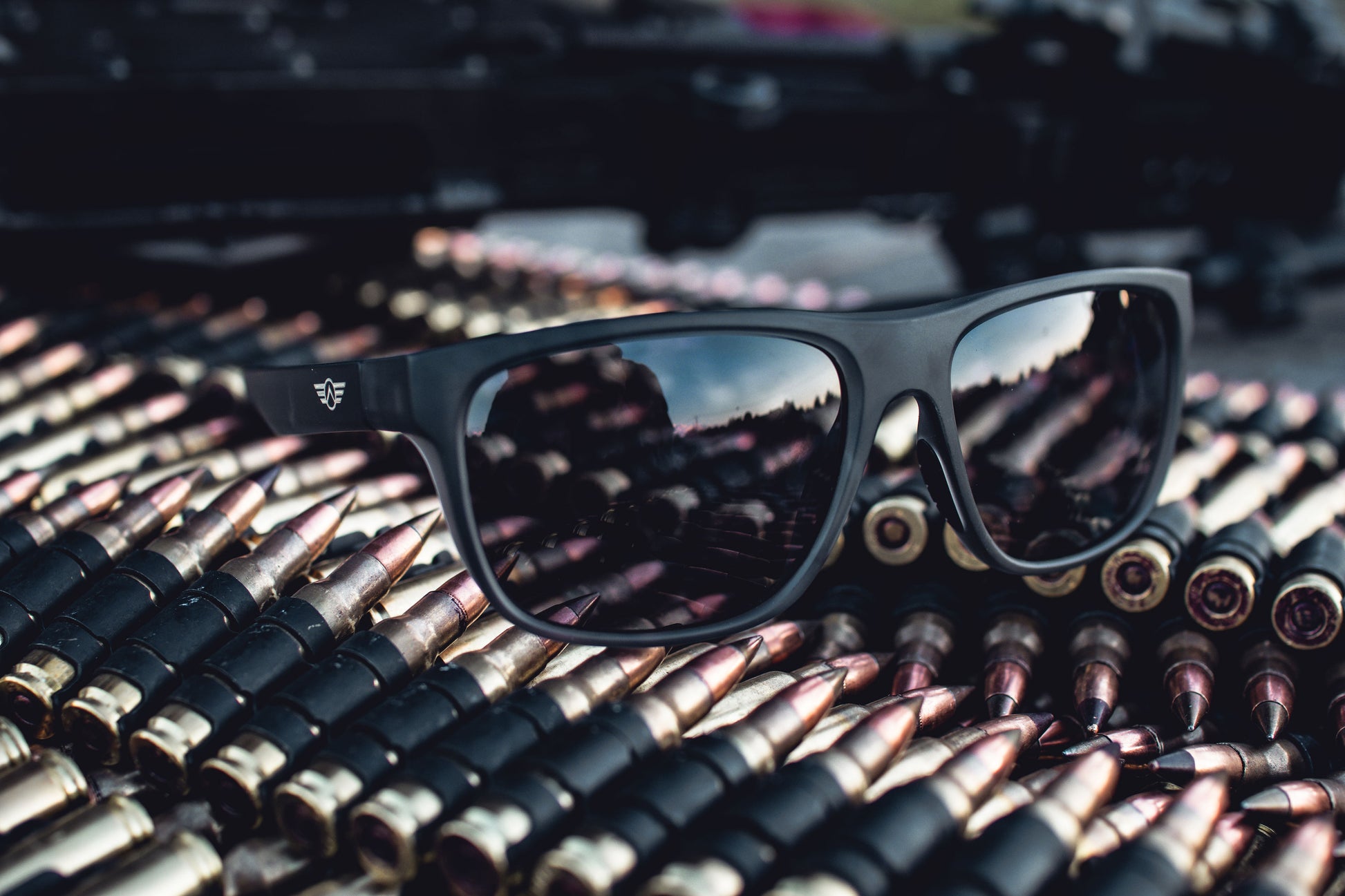 Black sunglasses on a pile of ammunition.