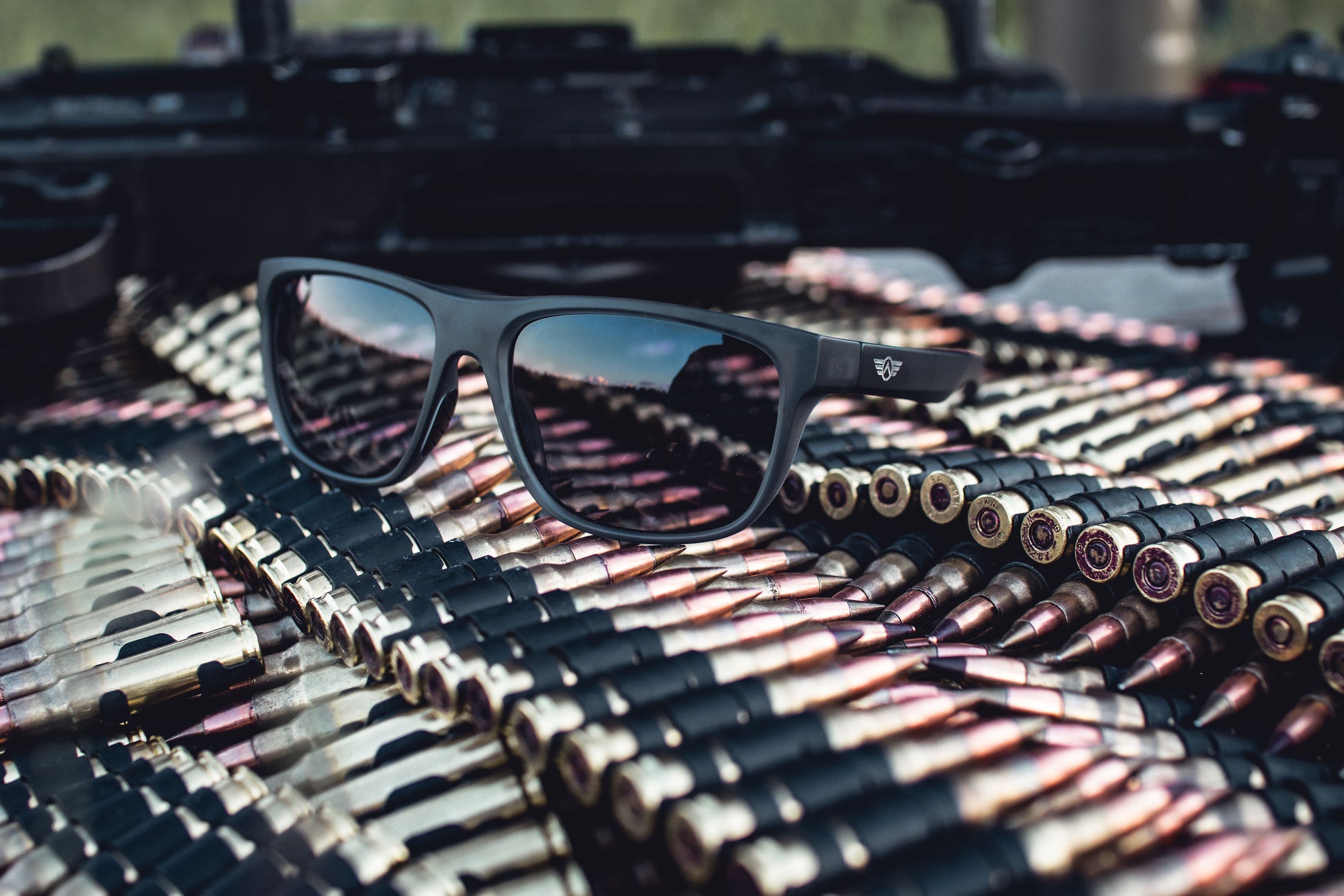 Sunglasses on a pile of ammunition with a blurred background