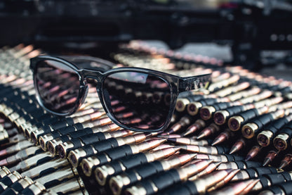 Sunglasses on a pile of ammunition with a blurred background