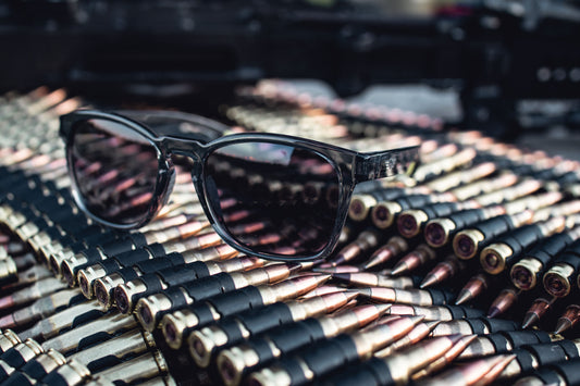 Sunglasses on a pile of ammunition with a blurred background