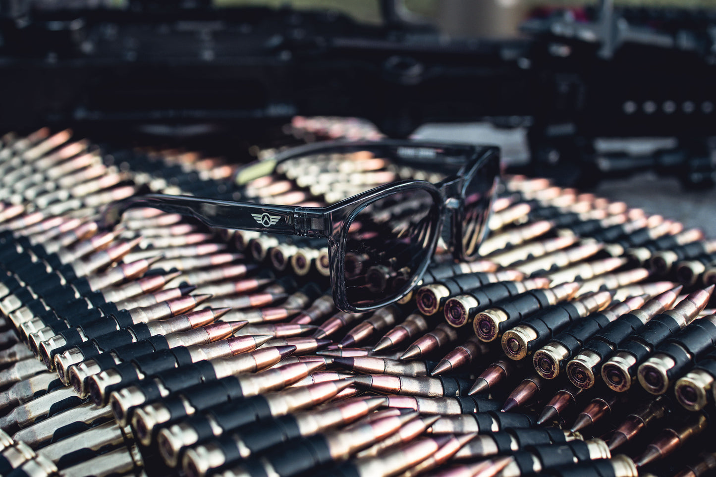 Sunglasses on a pile of bullets with a blurred background