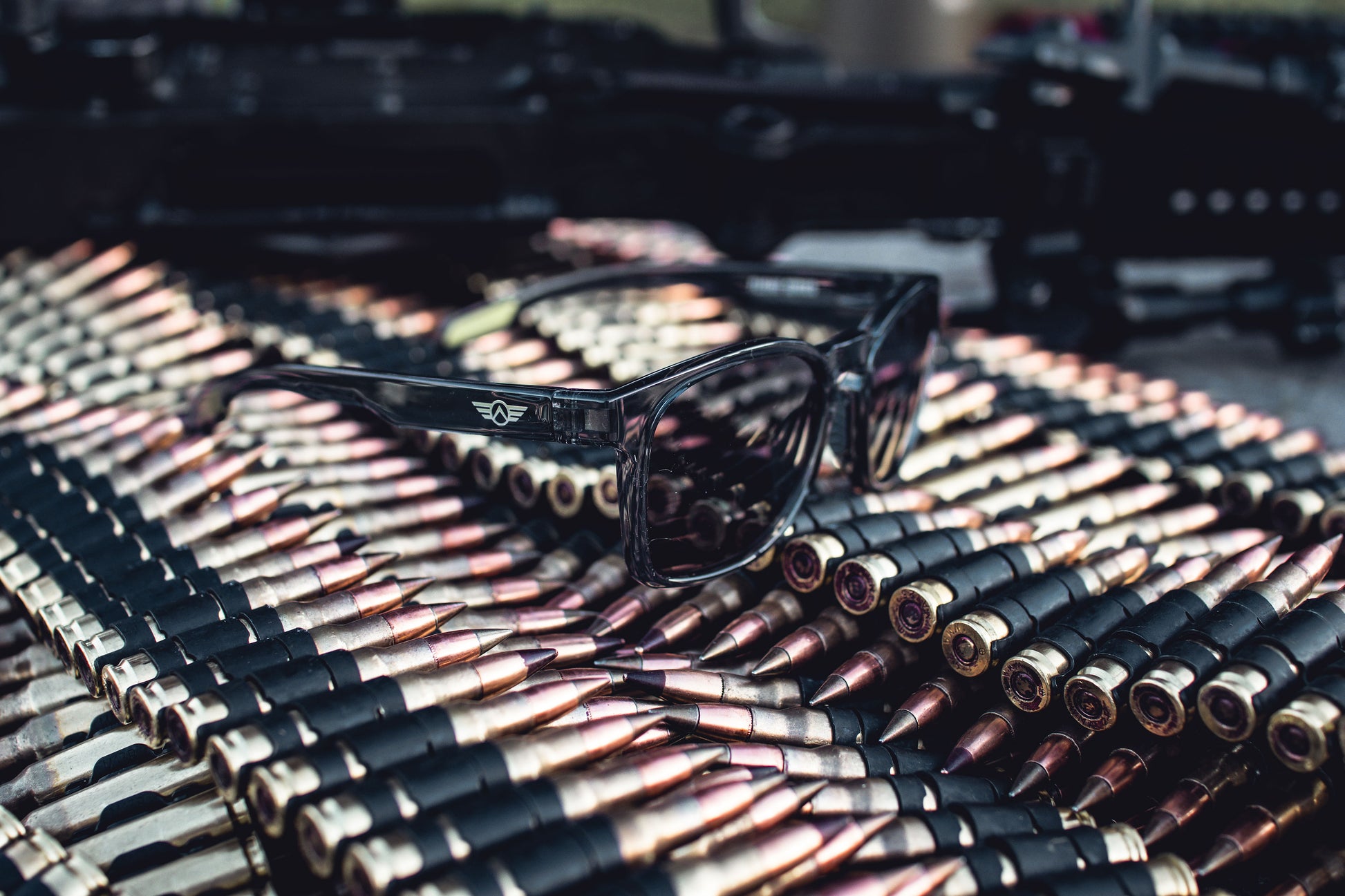 Sunglasses on a pile of bullets with a blurred background