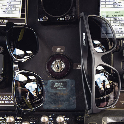 Sunglasses on a control panel with various buttons and displays