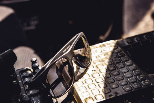 Sunglasses on a gold surface with a blurred background