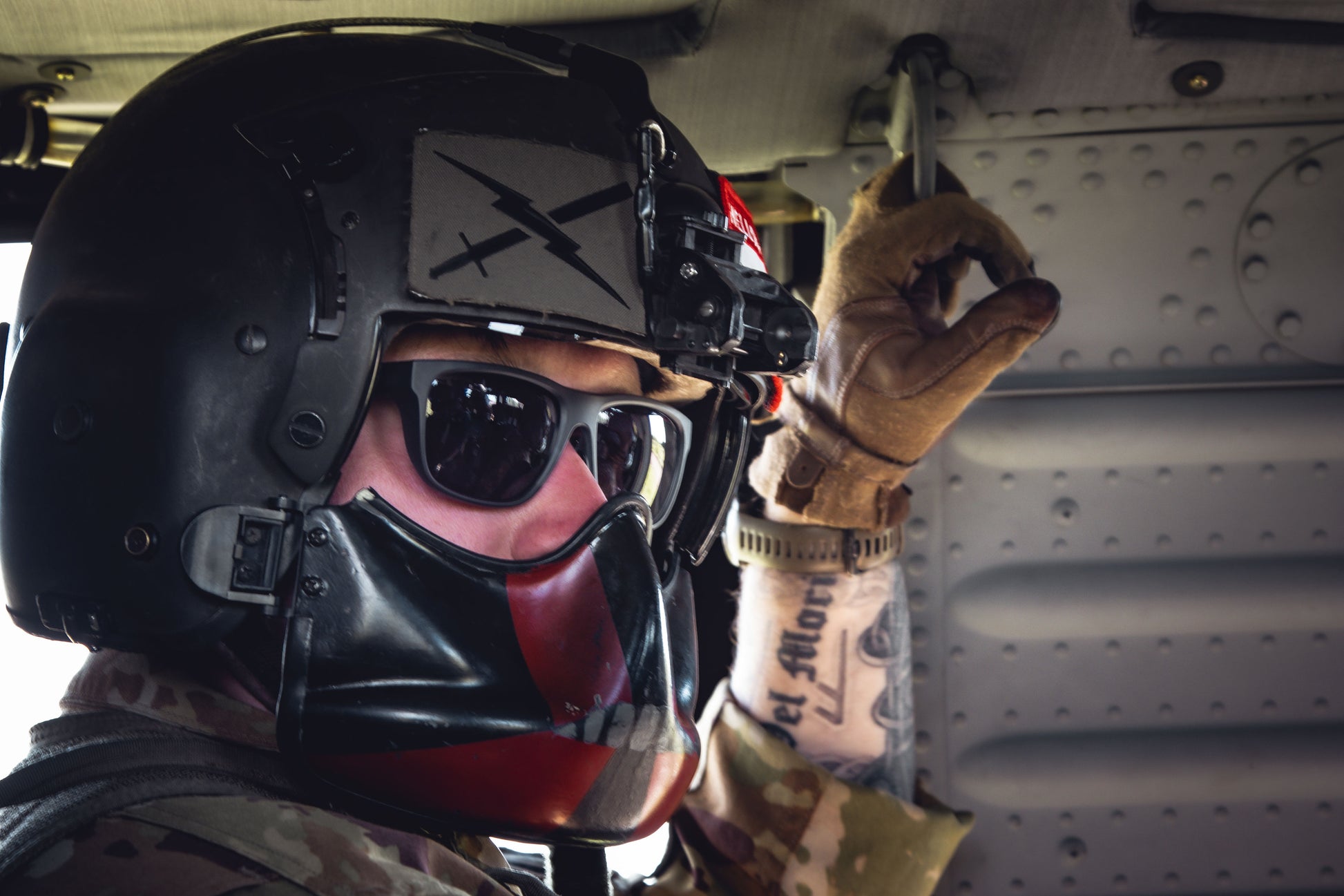 Person wearing a helmet and goggles inside a vehicle